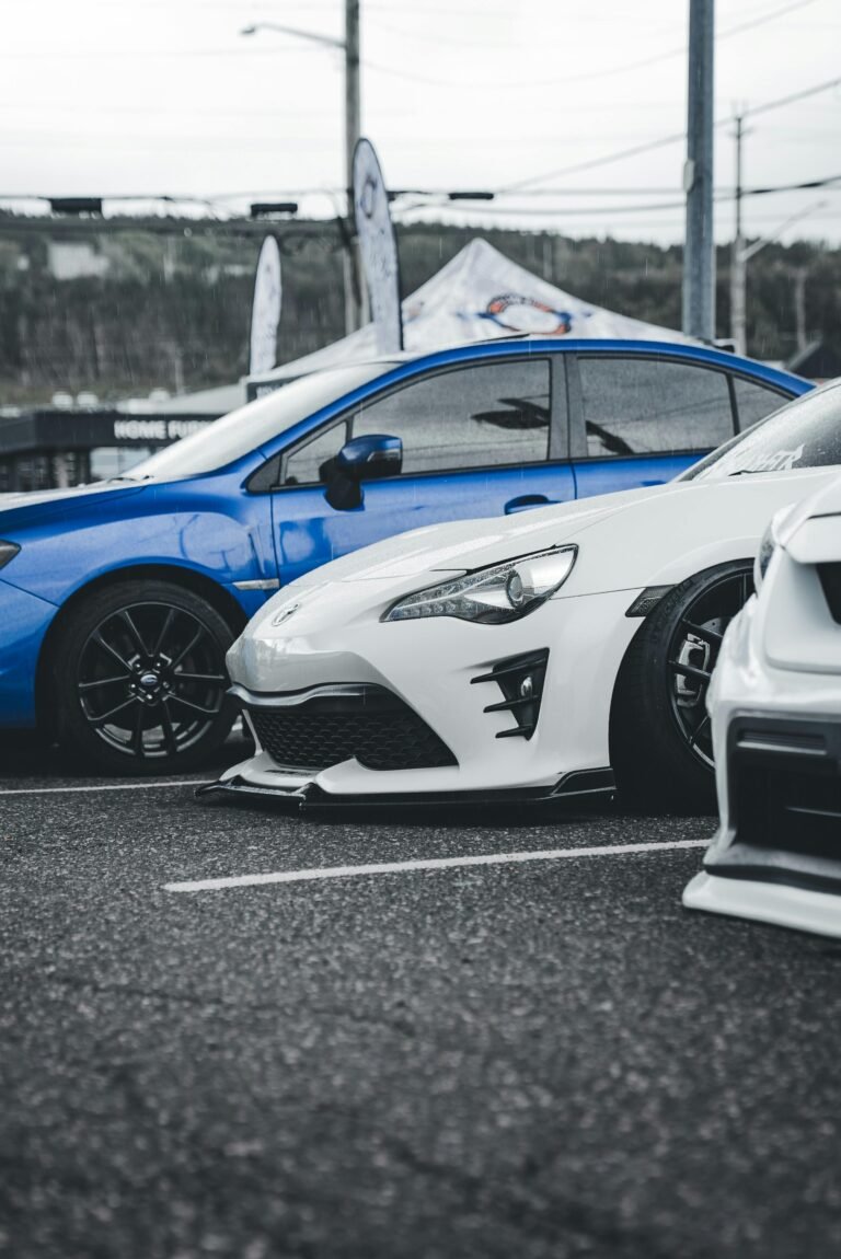 3 cars parked on black turf, parking is part of Automotive Essentails